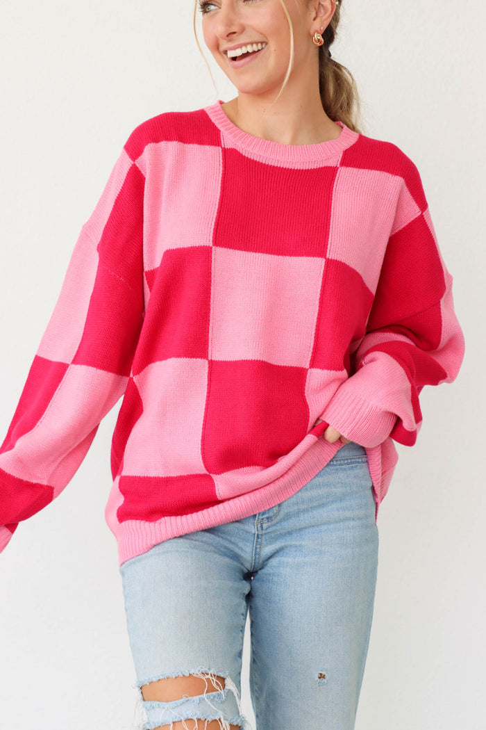 girl wearing pink and red checker print sweater