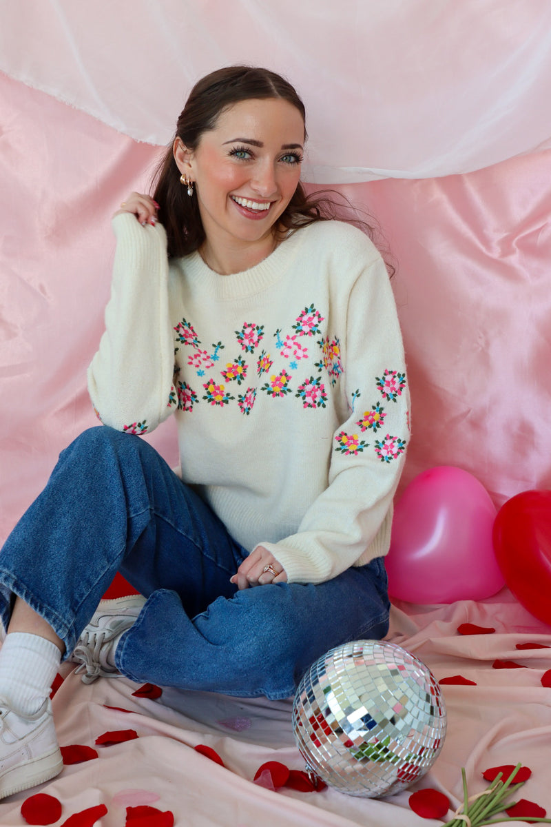 girl wearing cream floral sweater