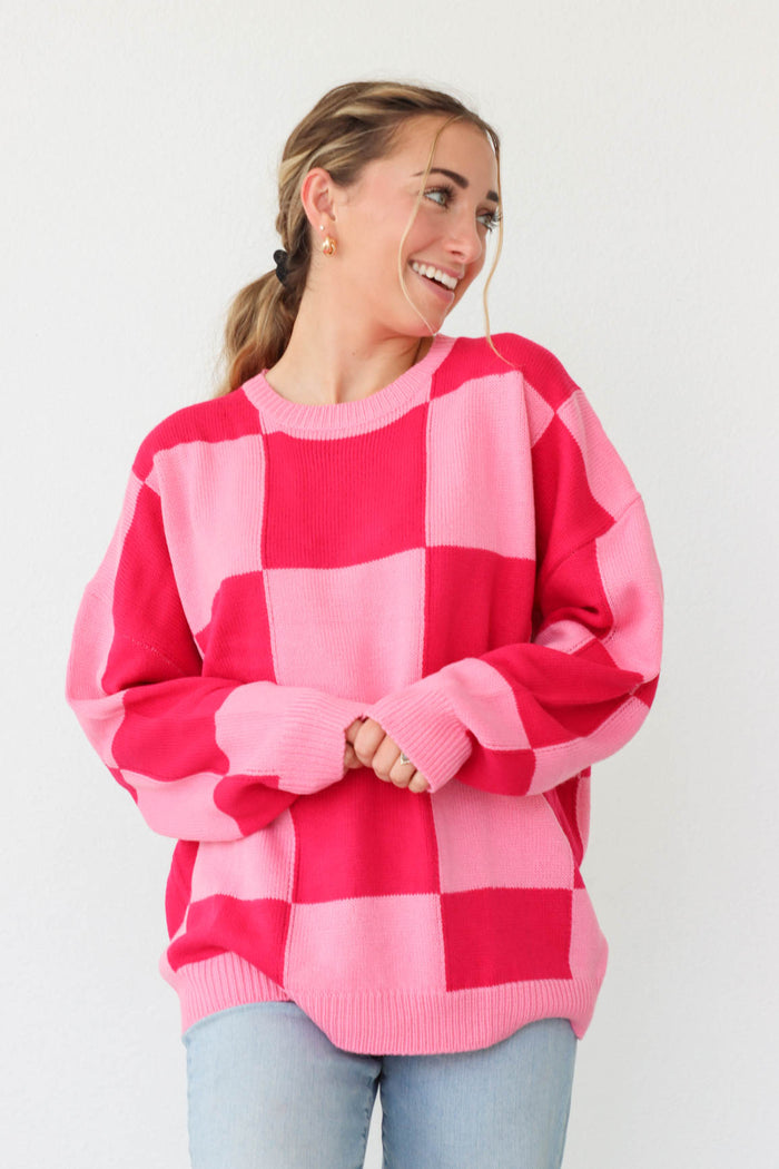 girl wearing pink and red checker print sweater