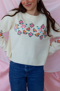 girl wearing cream floral sweater