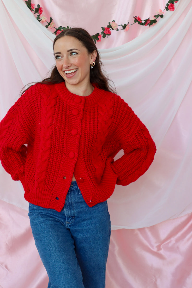 girl wearing red knit cardigan