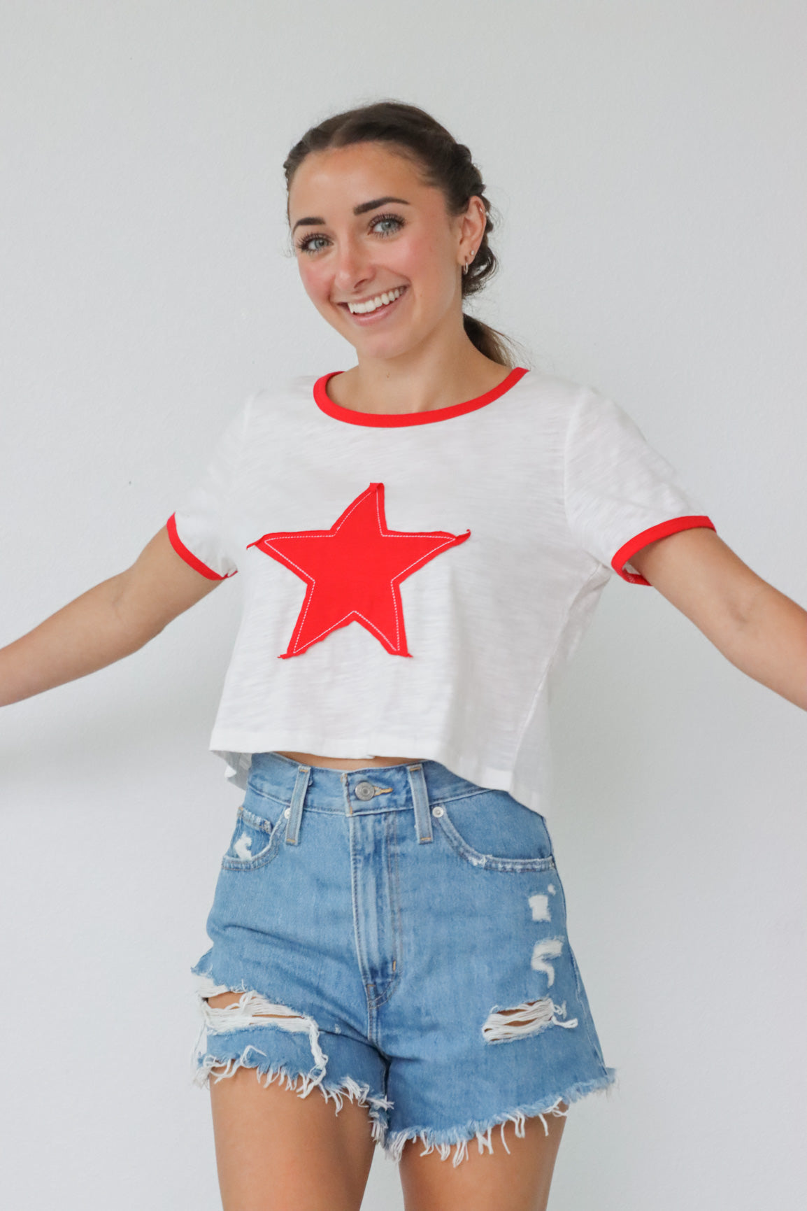 girl wearing white t-shirt with red embroidered heart detailing
