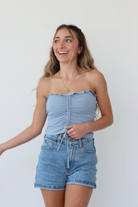 girl wearing light blue cropped strapless tube top