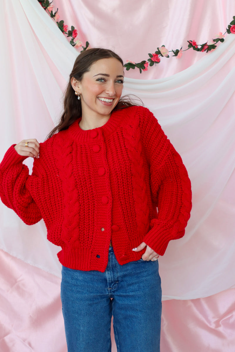 girl wearing red knit cardigan