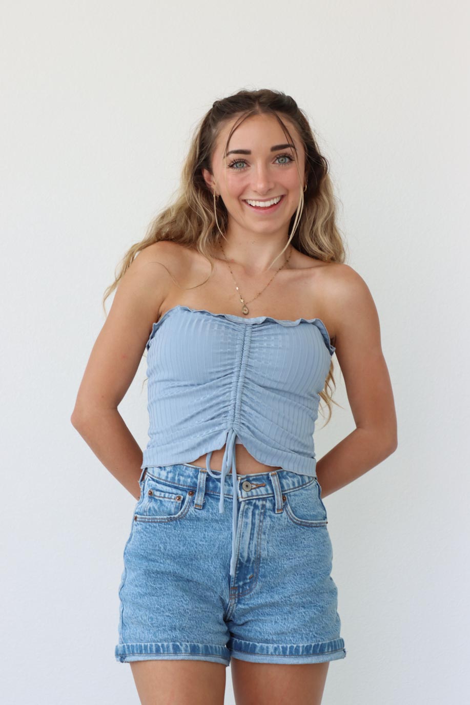 girl wearing light blue cropped strapless tube top