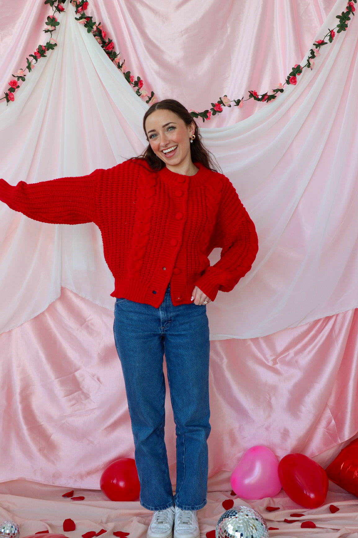 girl wearing red knit cardigan