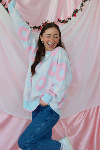 girl wearing light blue and pink xoxo sweater