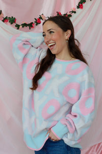 girl wearing light blue and pink xoxo sweater