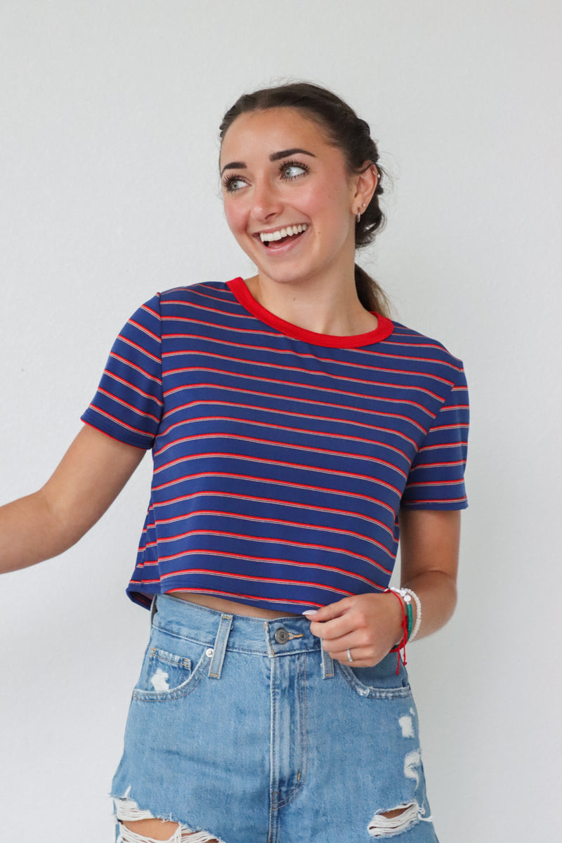 girl wearing red and blue striped cropped tee shirt