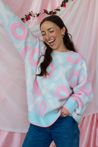 girl wearing light blue and pink xoxo sweater