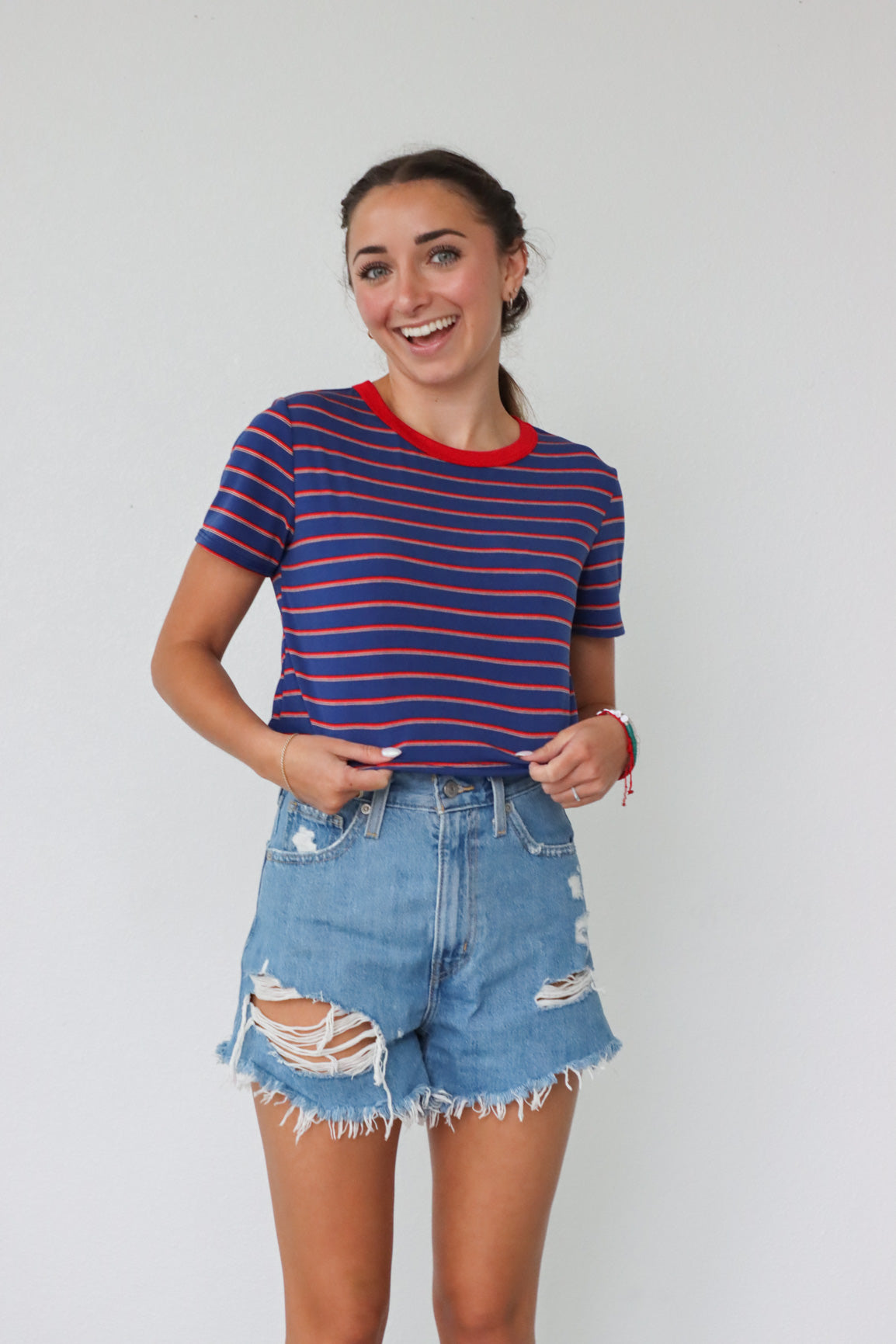girl wearing red and blue striped cropped tee shirt