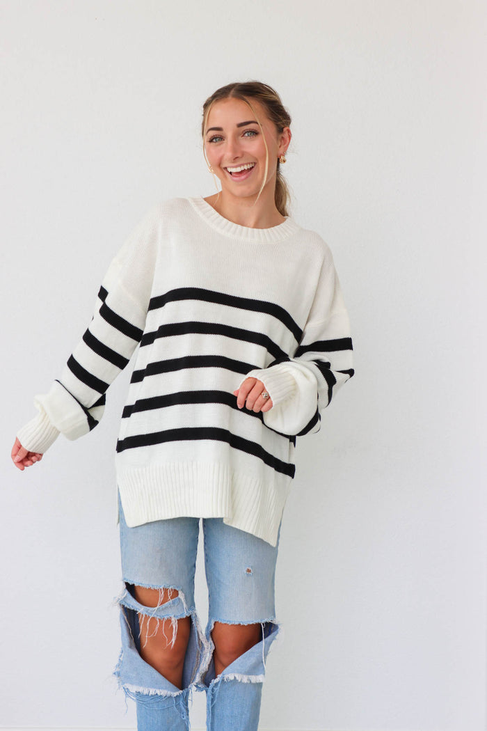 girl wearing white knit sweater with black stripes