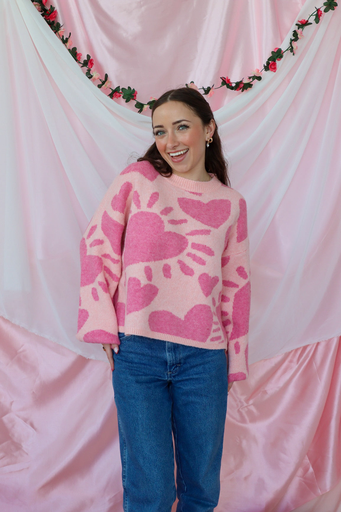 girl wearing pink heart sweater