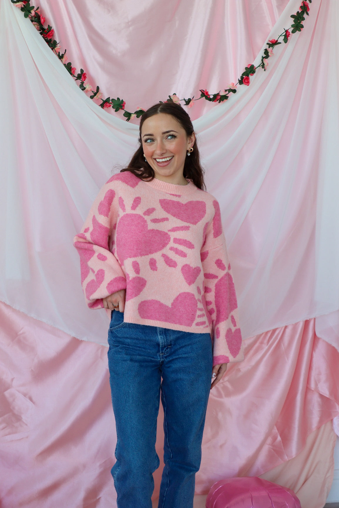 girl wearing pink heart sweater