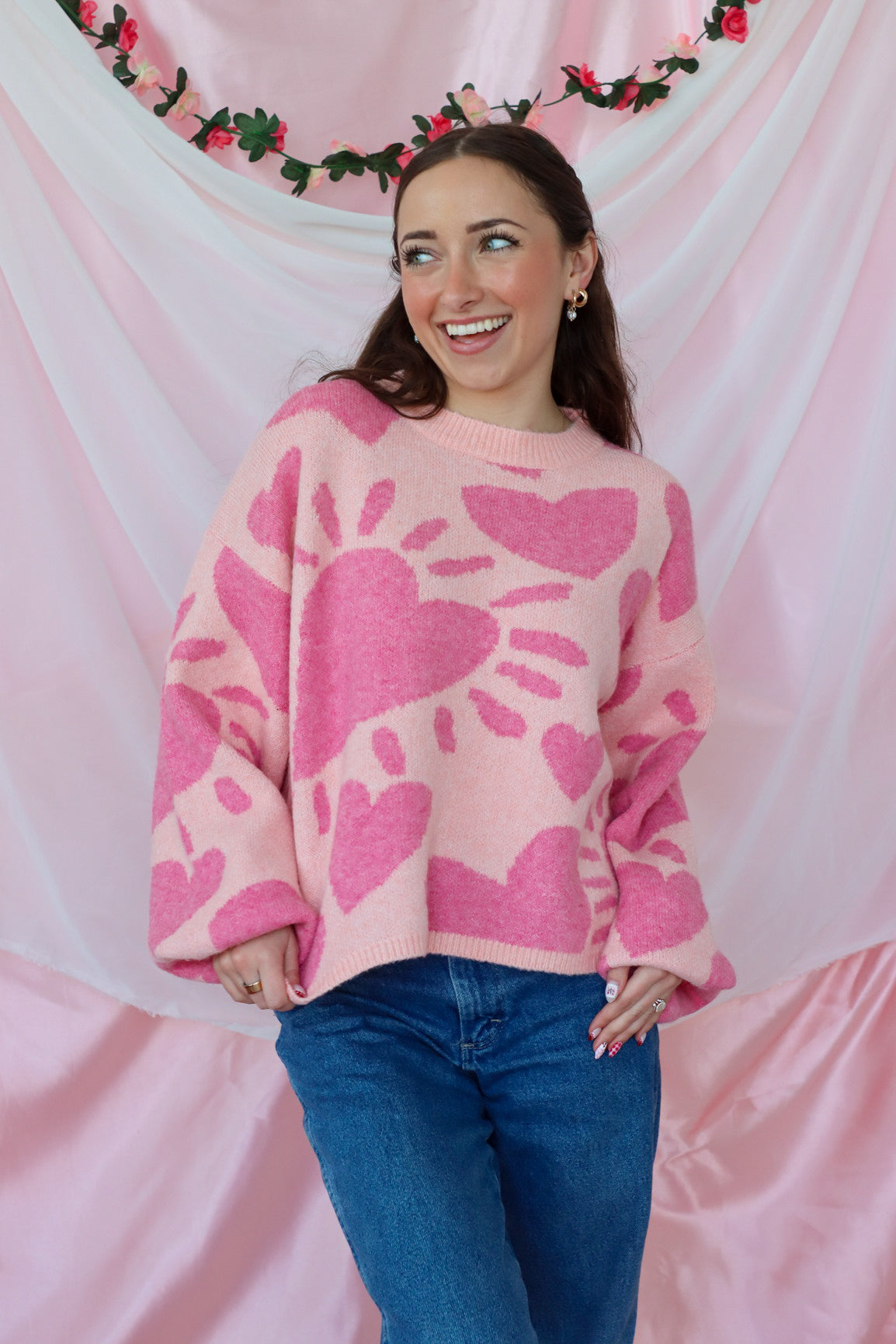 girl wearing pink heart sweater