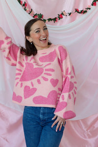 girl wearing pink heart sweater