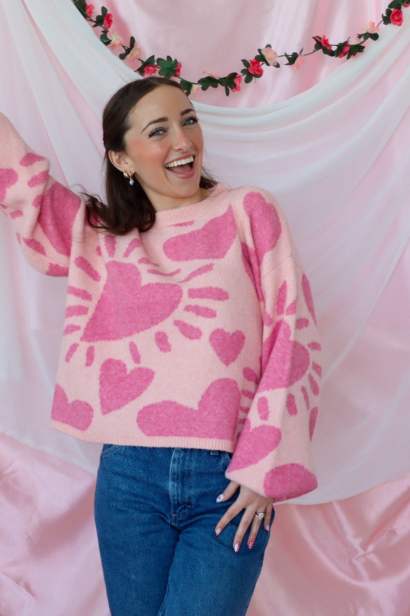 girl wearing pink heart sweater