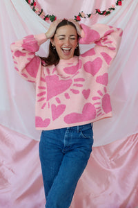 girl wearing pink heart sweater