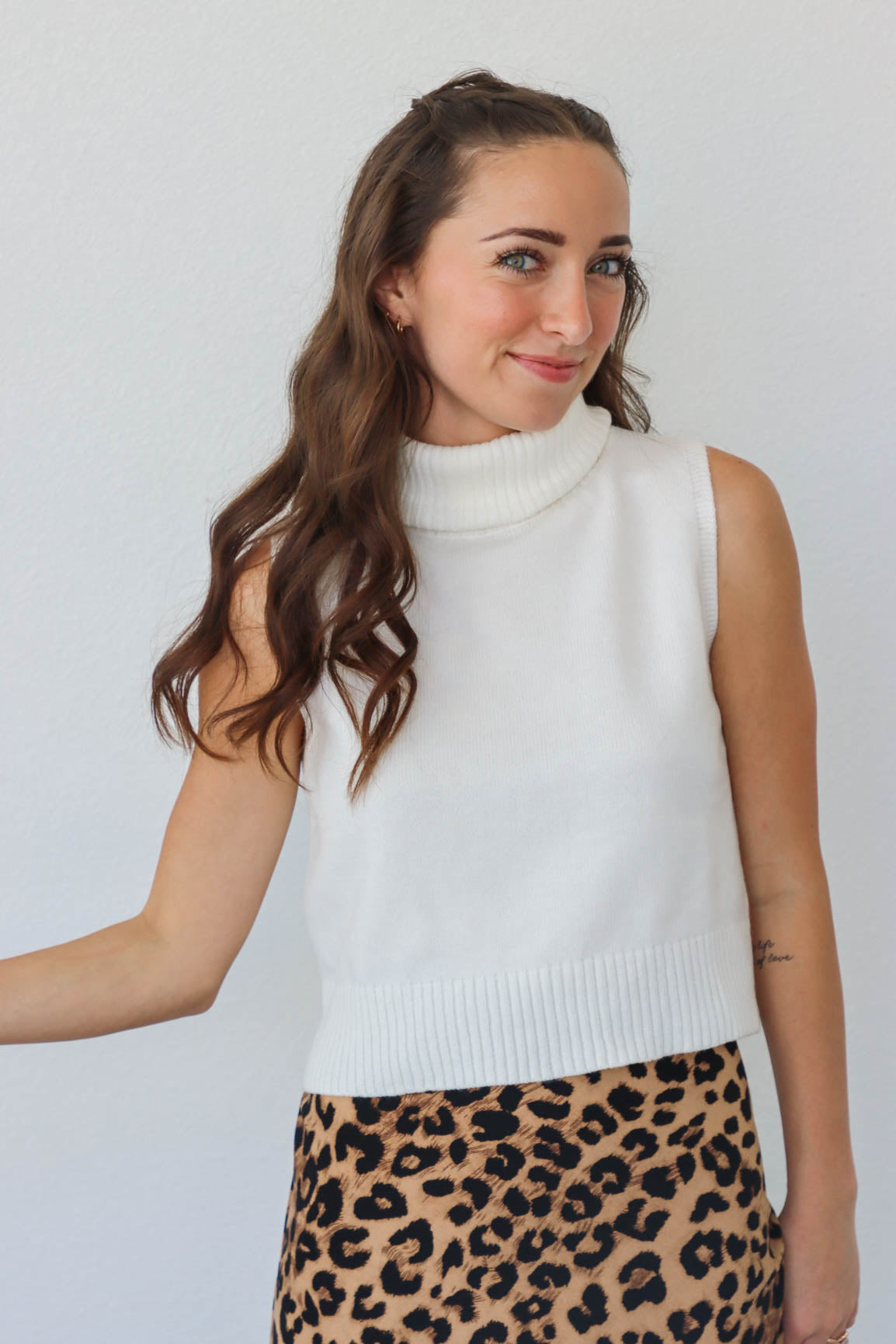 girl wearing white turtleneck knit tank top