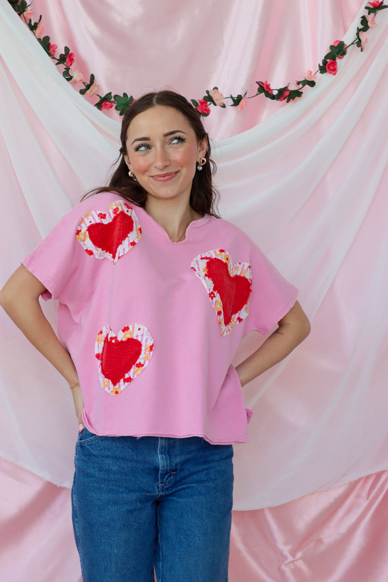 girl wearing pink heart tshirt