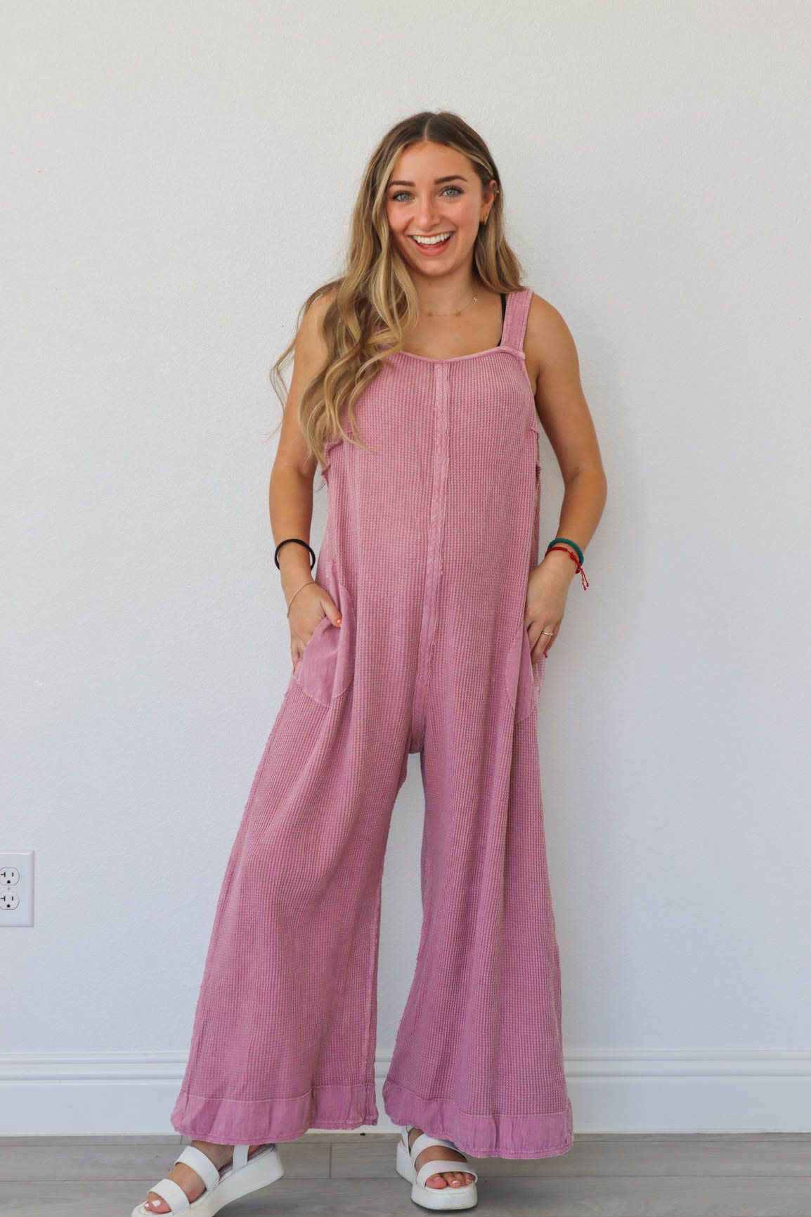 girl wearing pink waffle knit jumpsuit