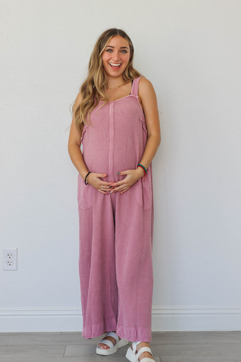 girl wearing pink waffle knit jumpsuit