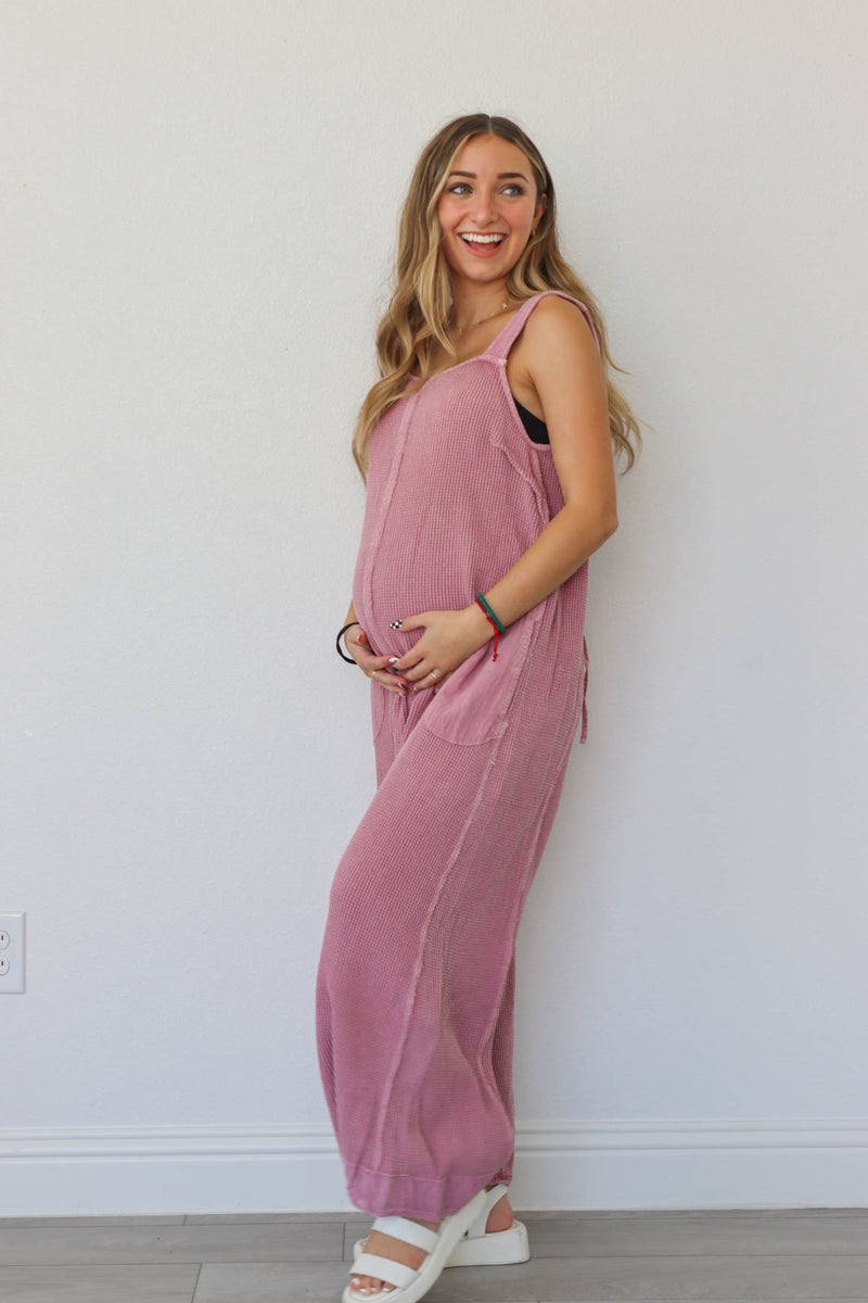 girl wearing pink waffle knit jumpsuit