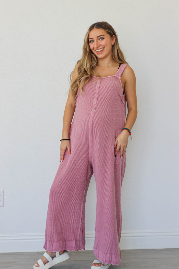 girl wearing pink waffle knit jumpsuit