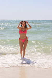 girl wearing hot pink terry cloth bikini
