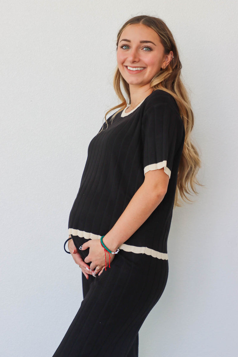 girl wearing black and cream matching set