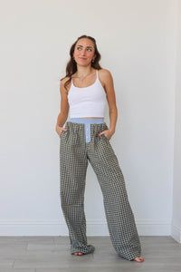 girl wearing brown/blue/green plaid pants