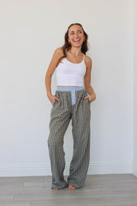 girl wearing brown/blue/green plaid pants