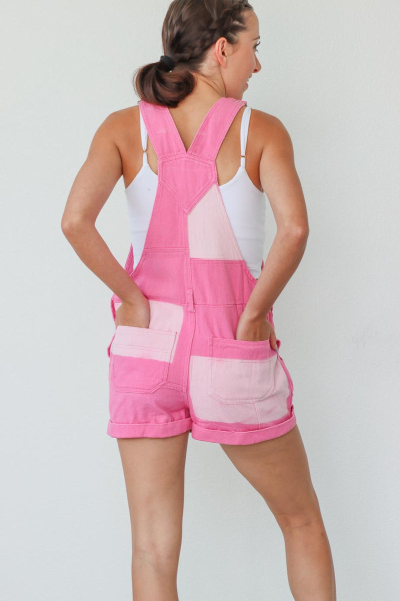 girl wearing hot pink patchwork overall shorts