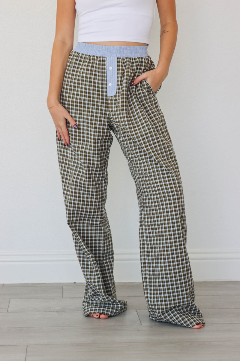 girl wearing brown/blue/green plaid pants