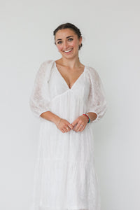 girl wearing long white dress with 3/4 sleeves