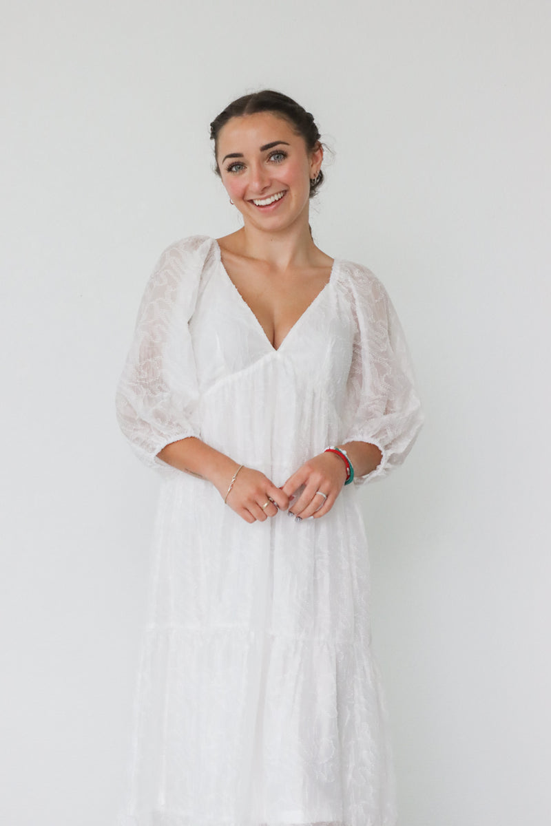 girl wearing long white dress with 3/4 sleeves