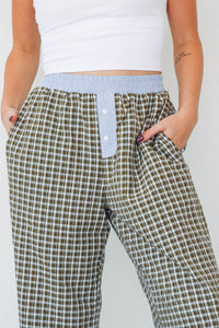 girl wearing brown/blue/green plaid pants