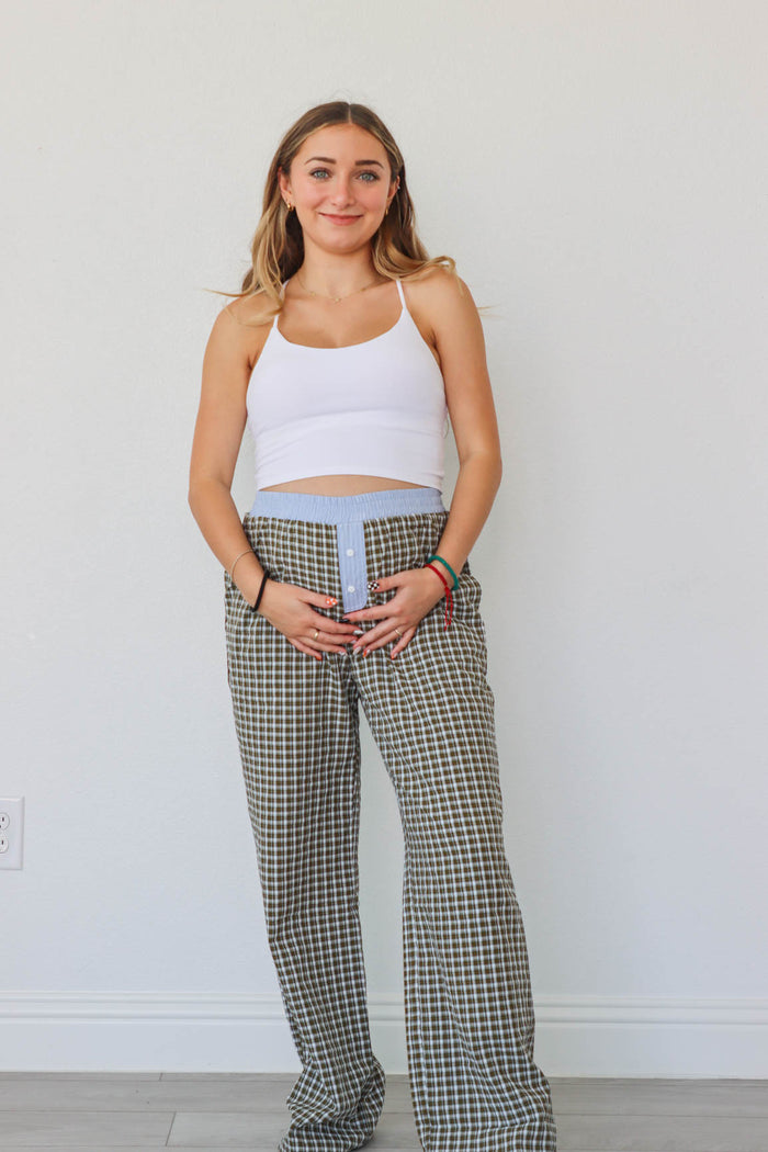 girl wearing brown/blue/green plaid pants