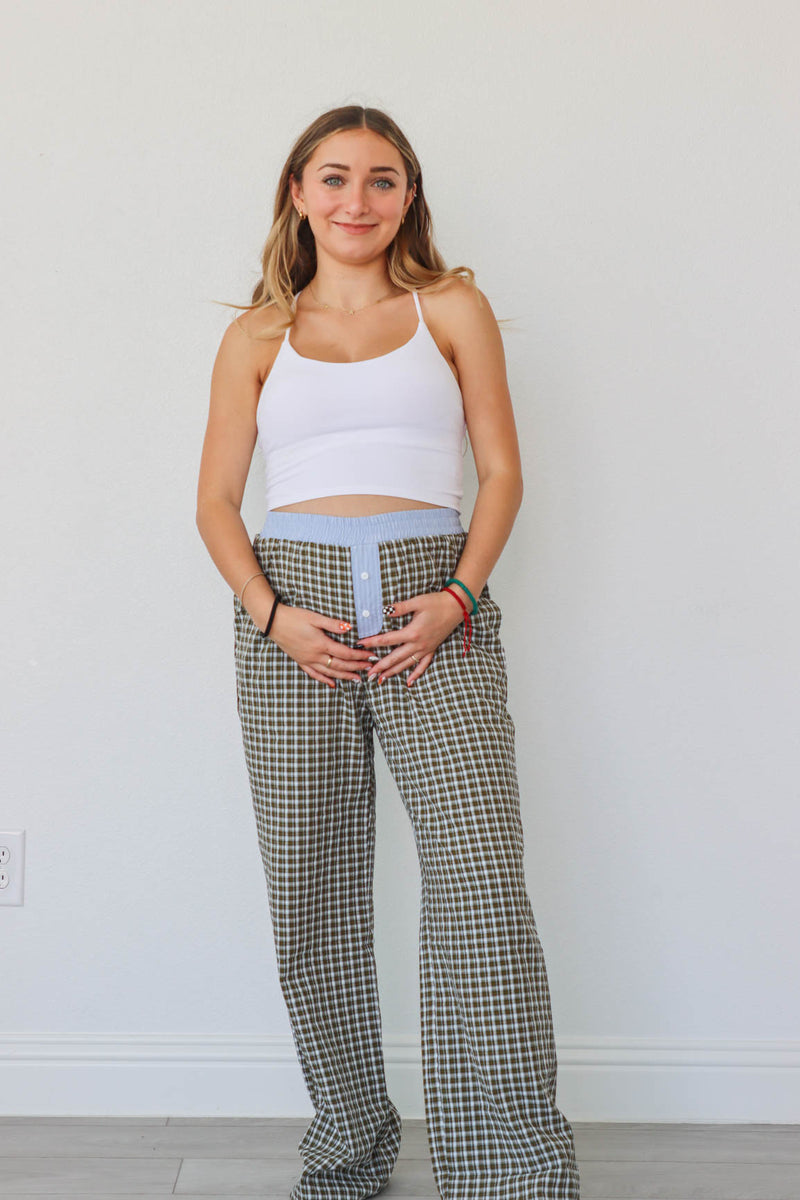 girl wearing brown/blue/green plaid pants