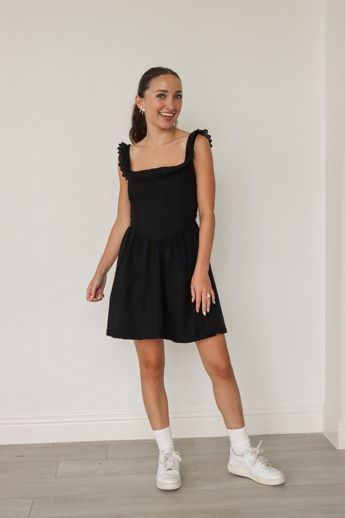 girl wearing short black dress
