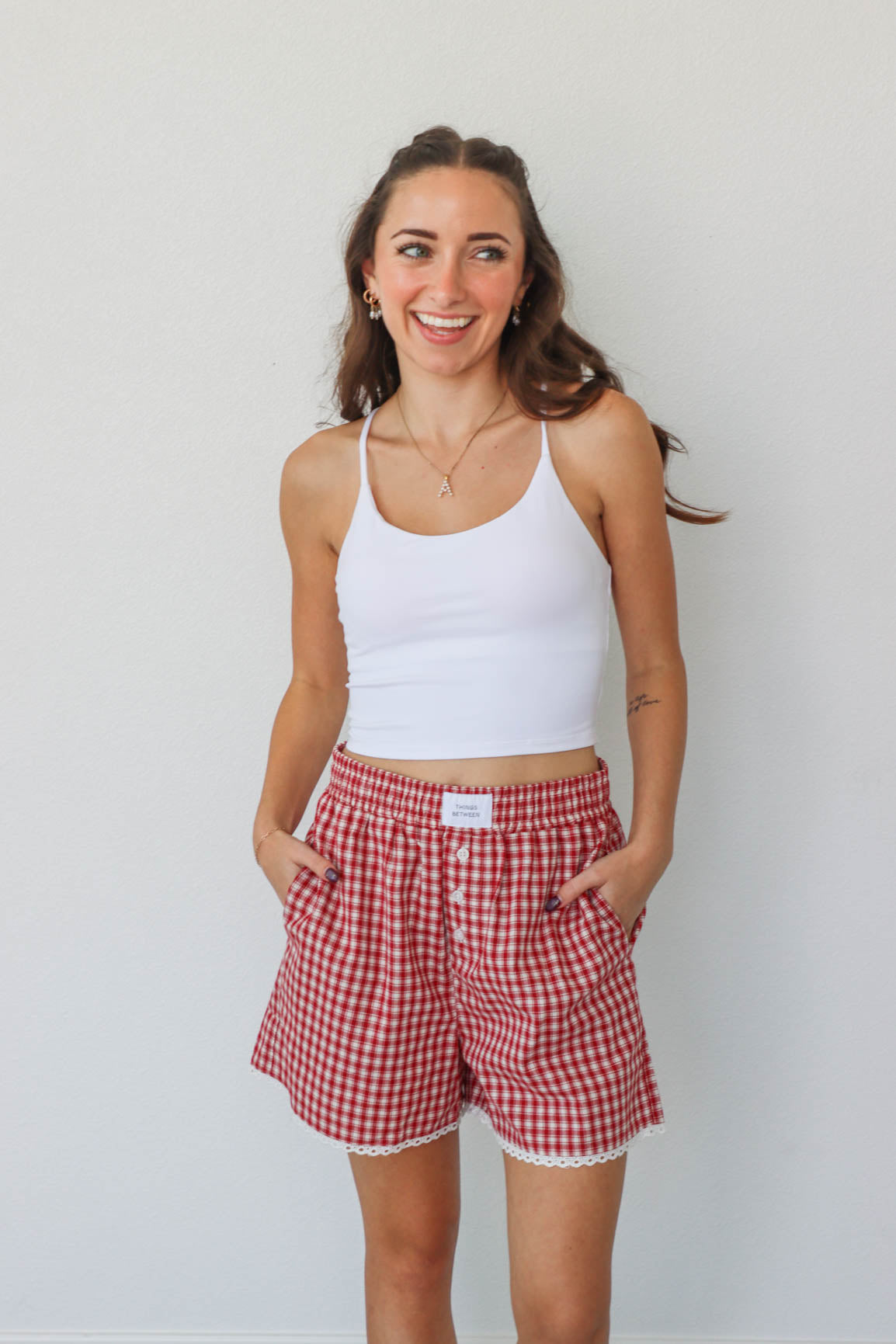 girl wearing red gingham boxer shorts