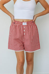 girl wearing red gingham boxer shorts