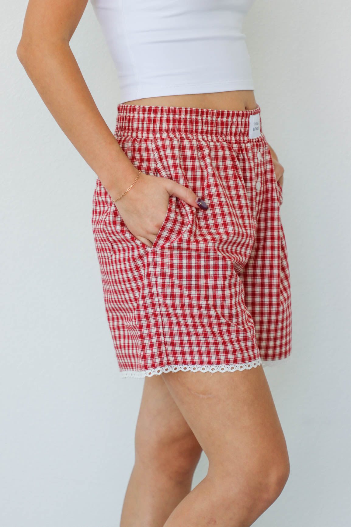 girl wearing red gingham boxer shorts