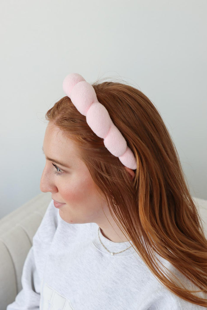 girl wearing pink terry cloth headband