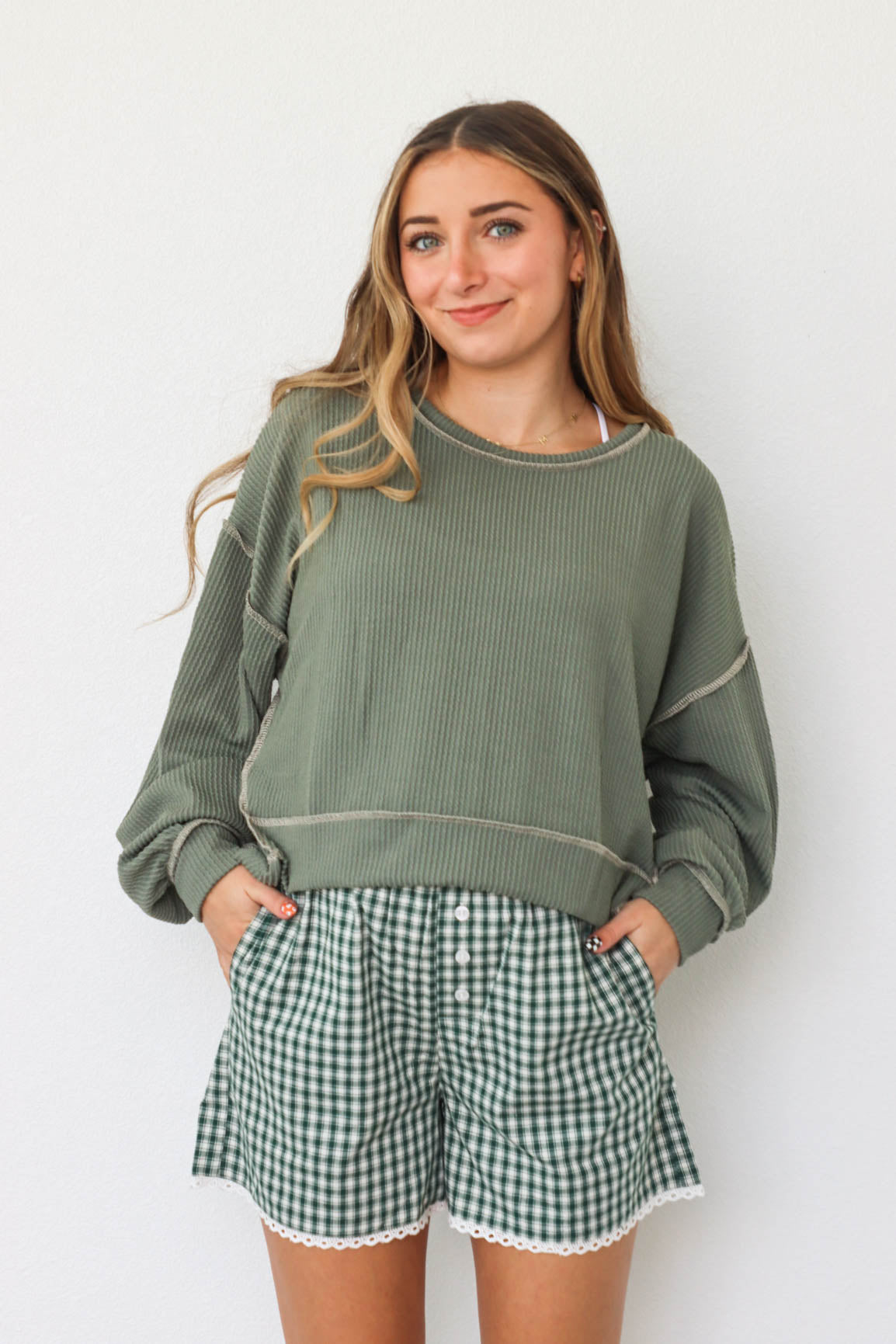 girl wearing green waffle knit shirt