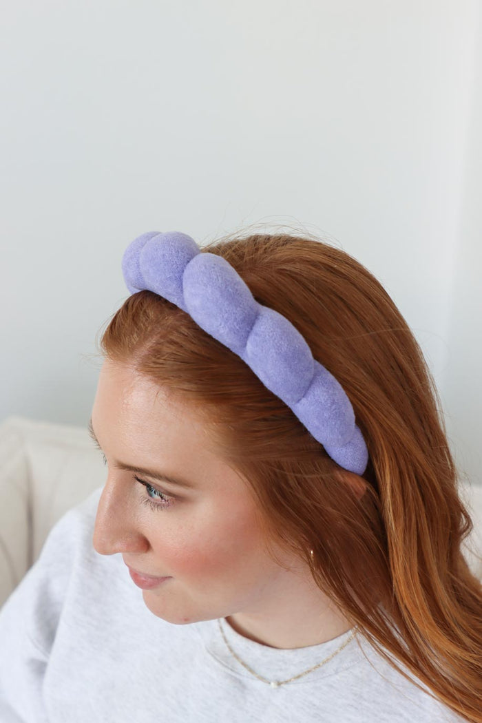 girl wearing purple terry cloth headband