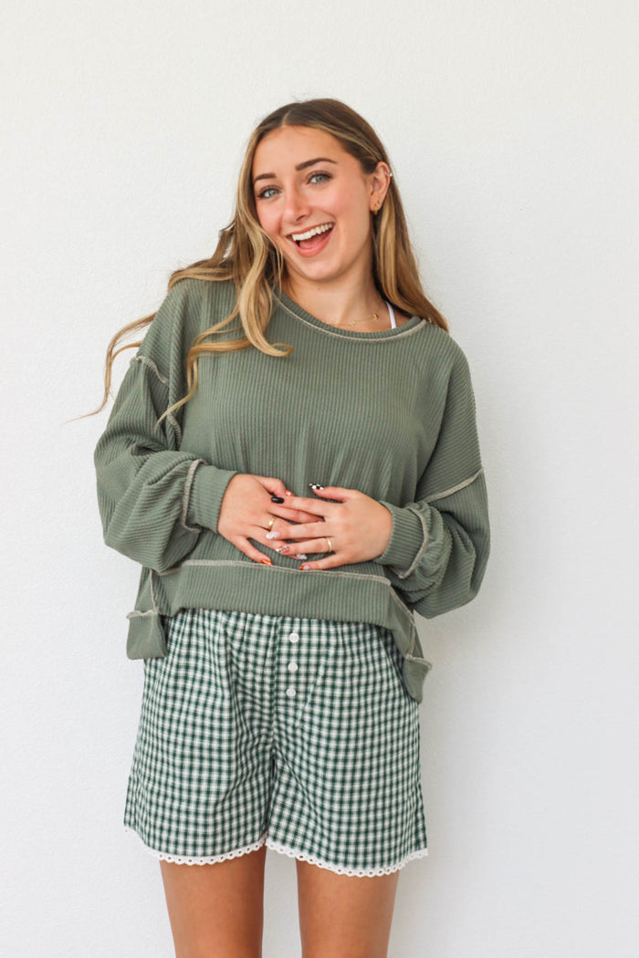 girl wearing green waffle knit shirt