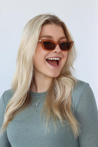 girl wearing light brown sunglasses