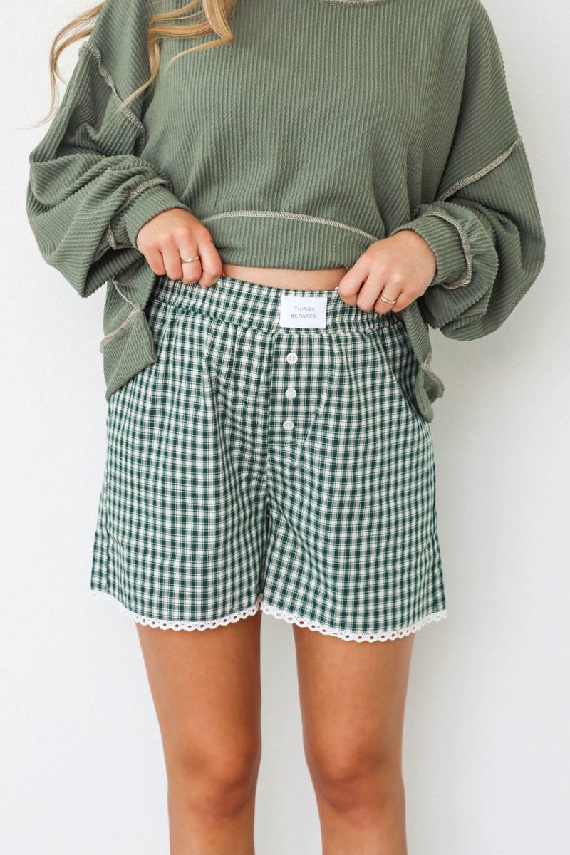 girl wearing green gingham boxer shorts