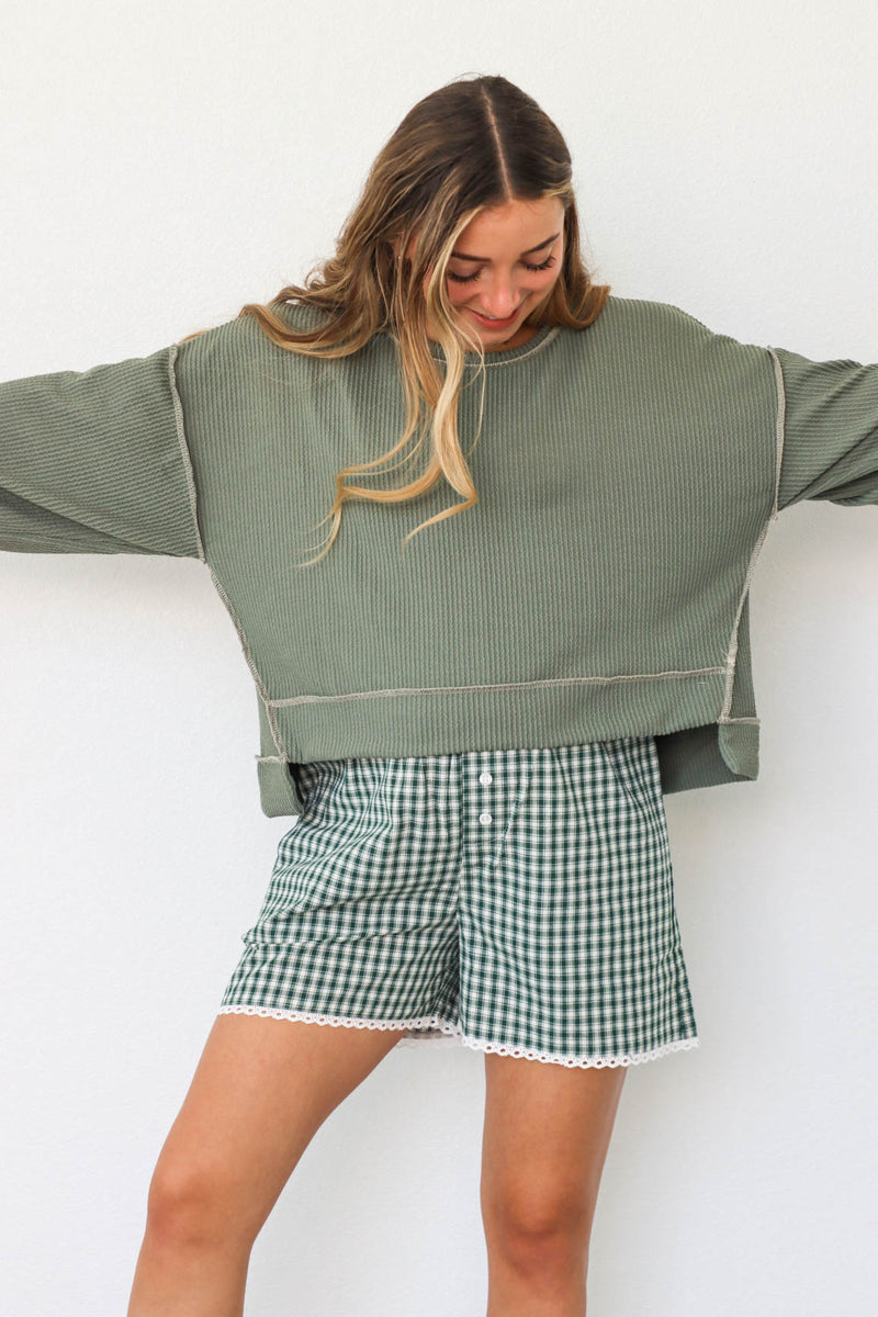 girl wearing green waffle knit shirt